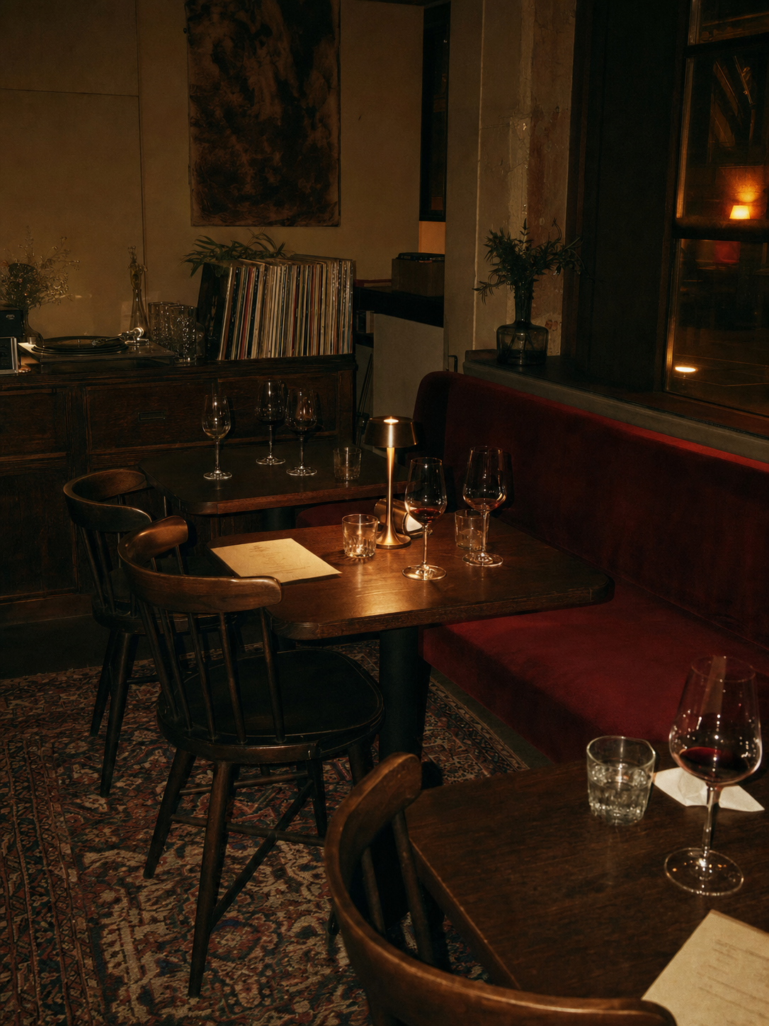 Listening room art direction. Low light, real records, seating built for staying rather than turning tables.