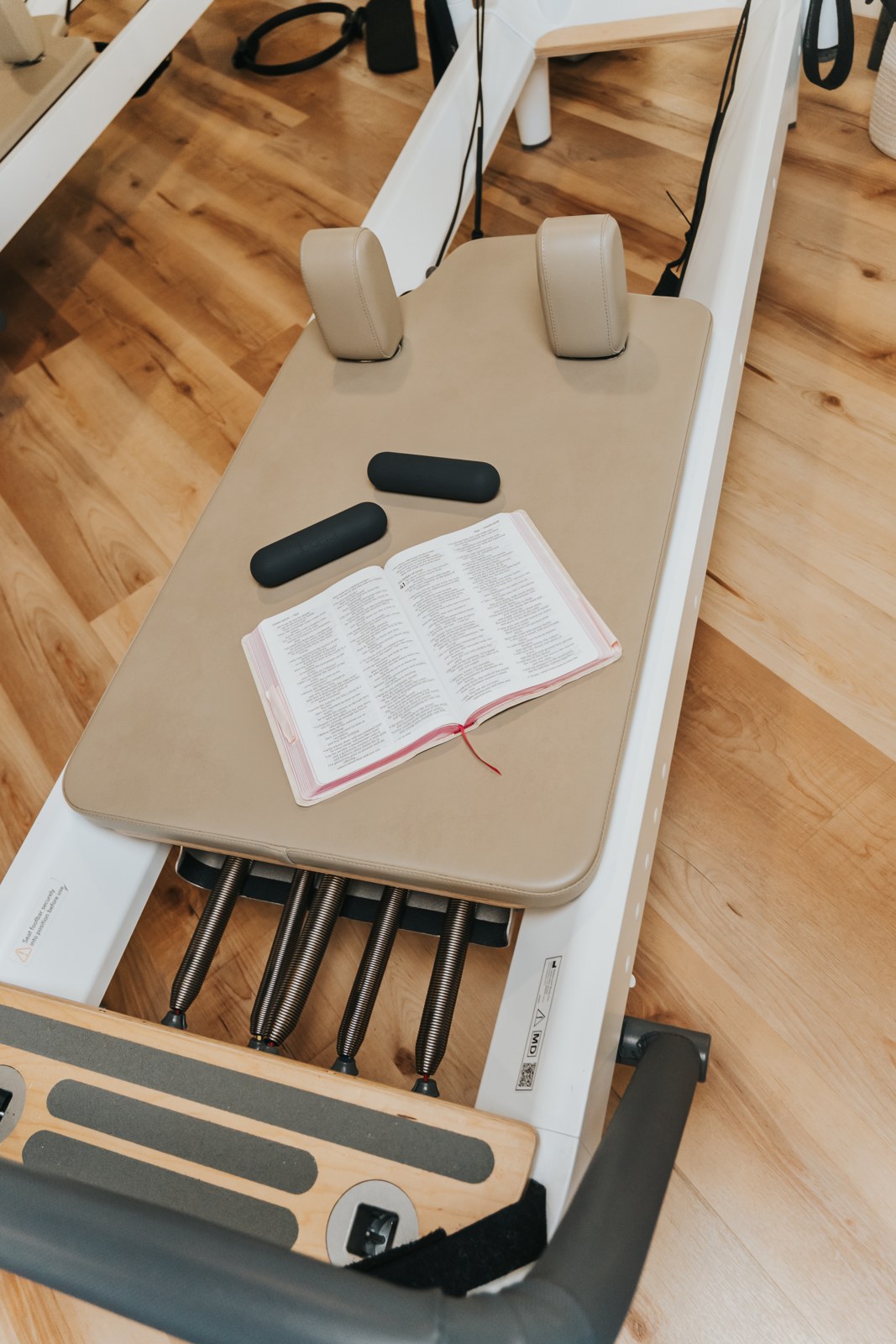 An open Bible on a Pilates reformer at Prayers & Pilates