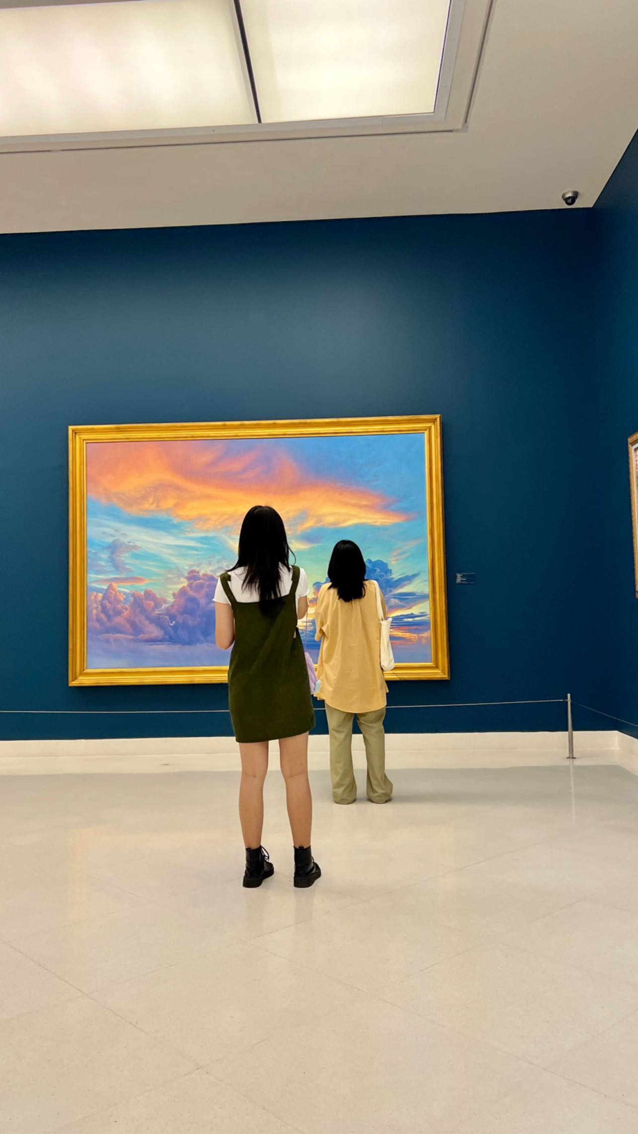 Visitors experiencing artwork in a blue-walled gallery