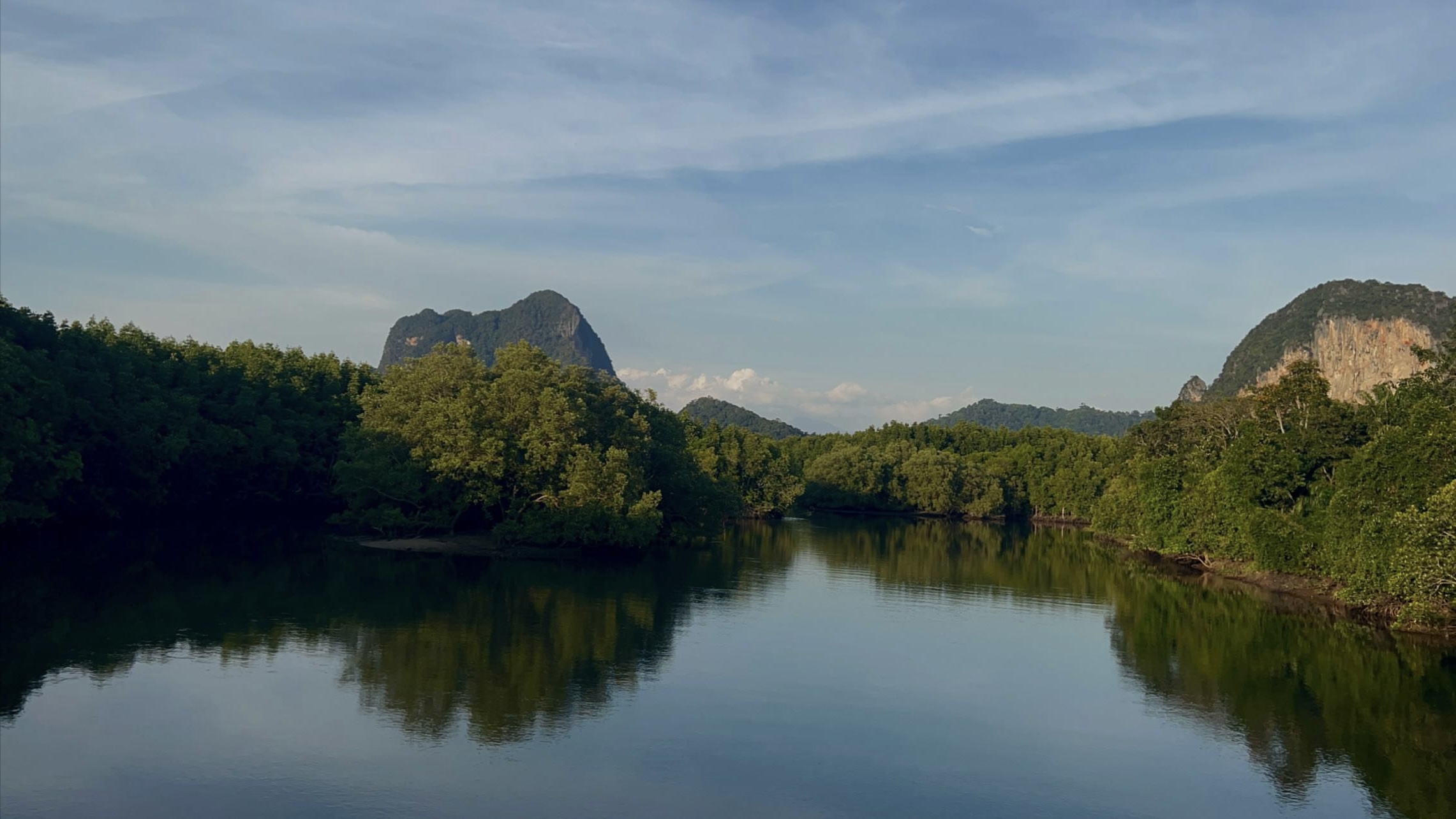 Green mountain scenery reflected in a still river